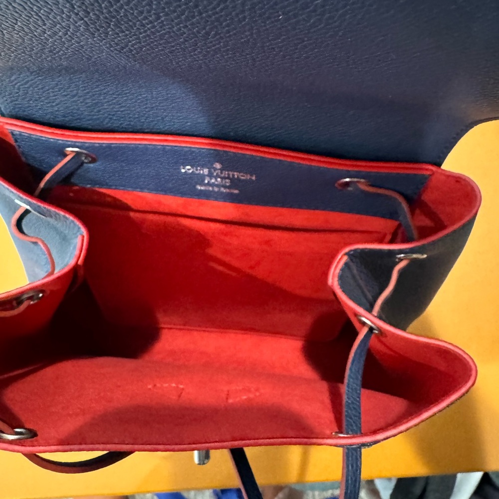 New never used, rare lock me backpack. Navy blue with red interior. Inc. dustbag